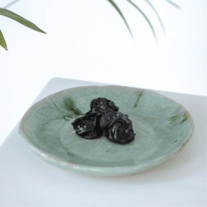 Ręcznie wykonany ceramiczny talerz, w kolorze pistacjowym z motywem liścia łopianu, idealnie nada się do podania jedzenia